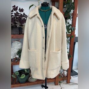 Light cream colored  button up jacket.
